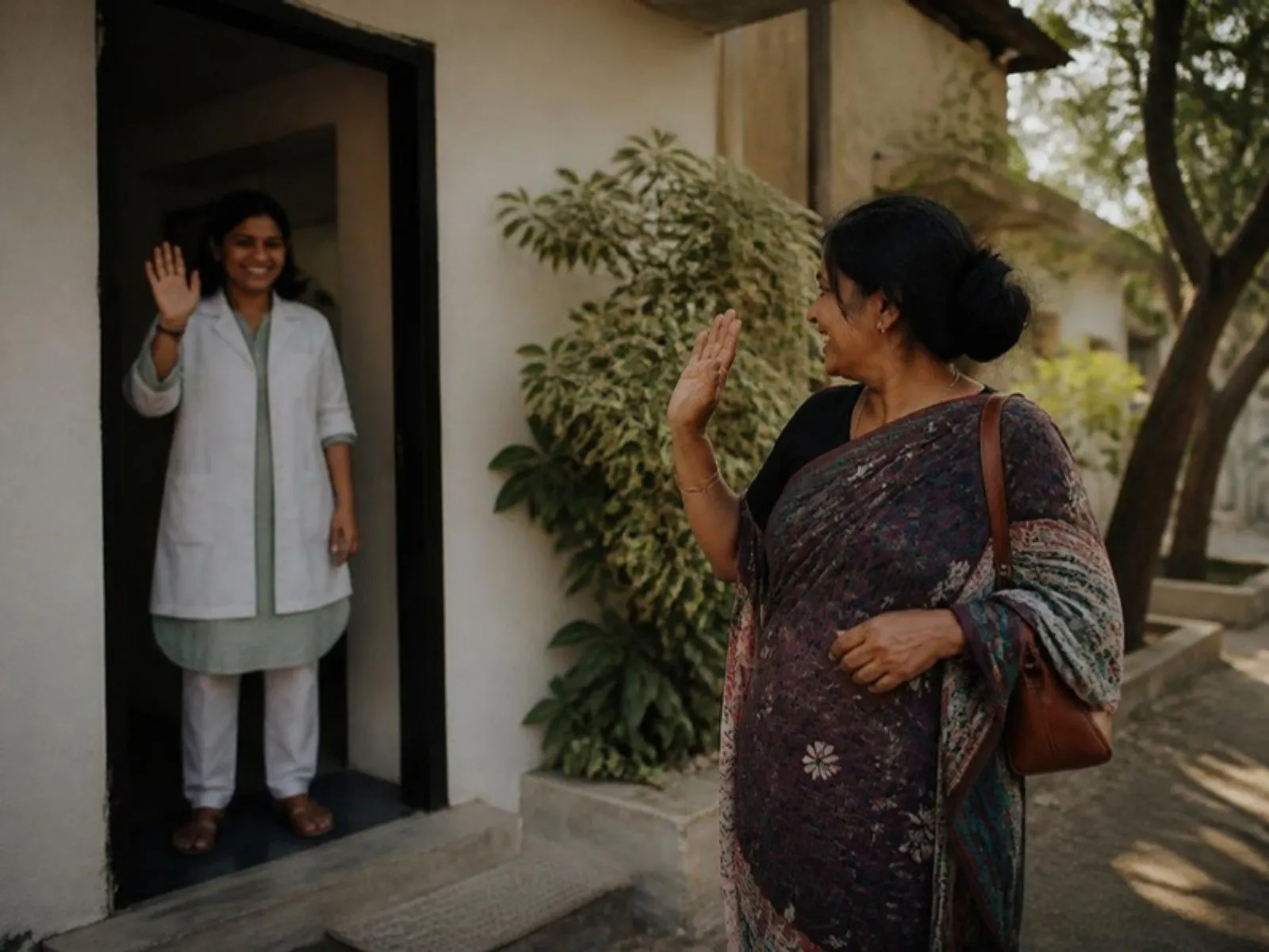 A patient leaving a clinic, turning to wave at the doctor at the door. Daylight, relaxed, genuine.